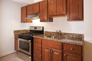 Kitchen with marble countertop and wood cabinets